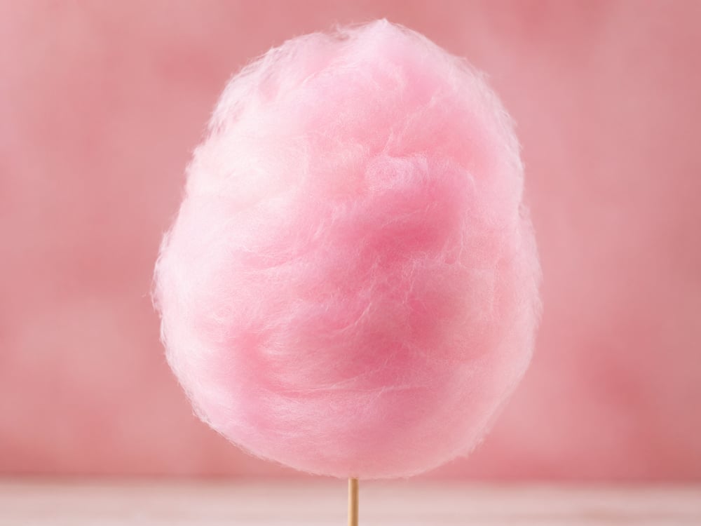 Pastel pink cotton candy on a stick